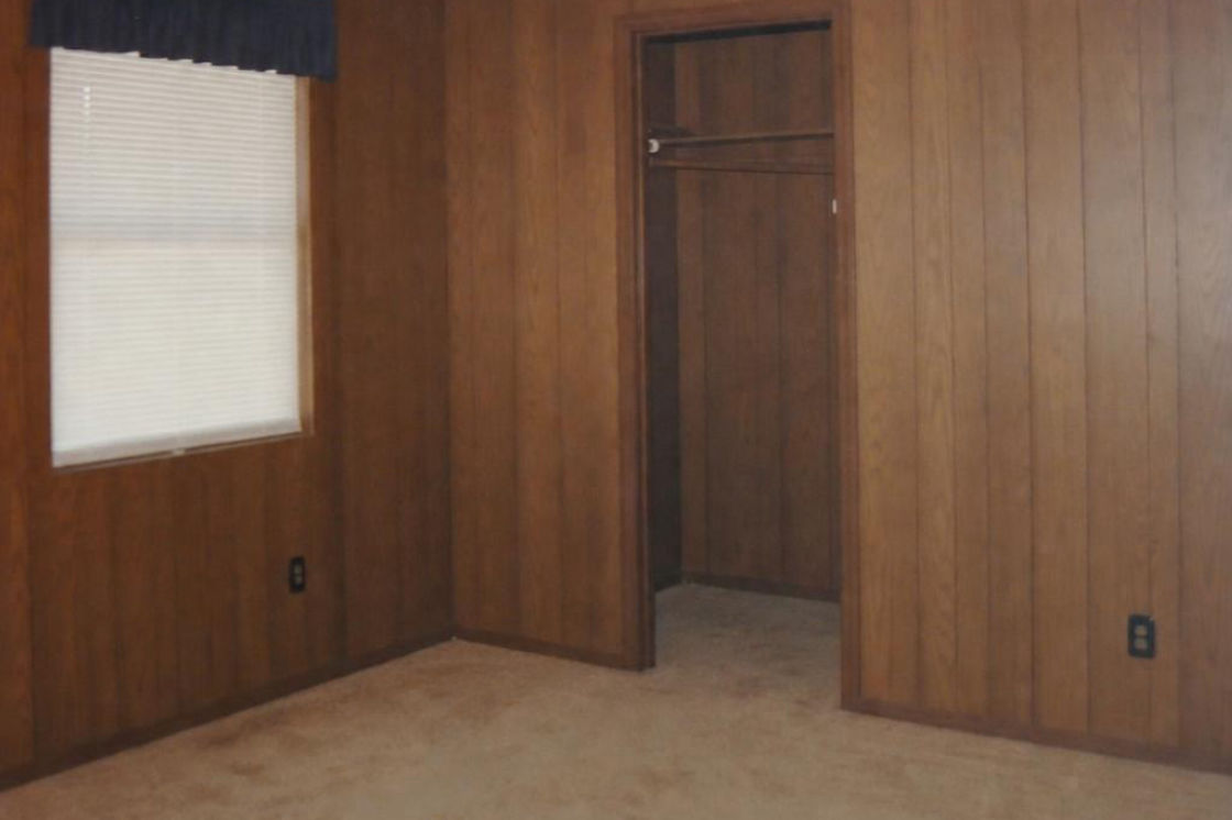 Before: a wood-panelled bedroom with a single bed and a small window.